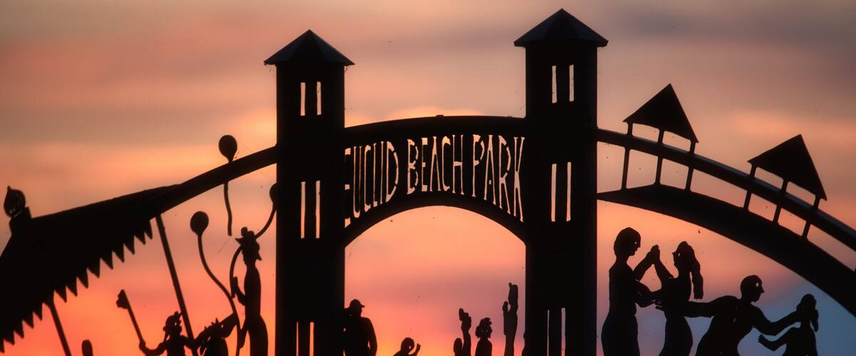 A silhouette of a park entrance with the name 'JULIUS BEACH PARK' and a lamp post.