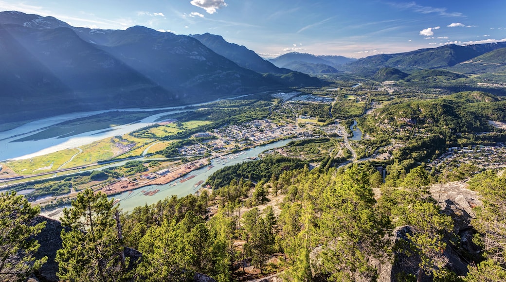 A mountainous landscape with a river flowing through a town.