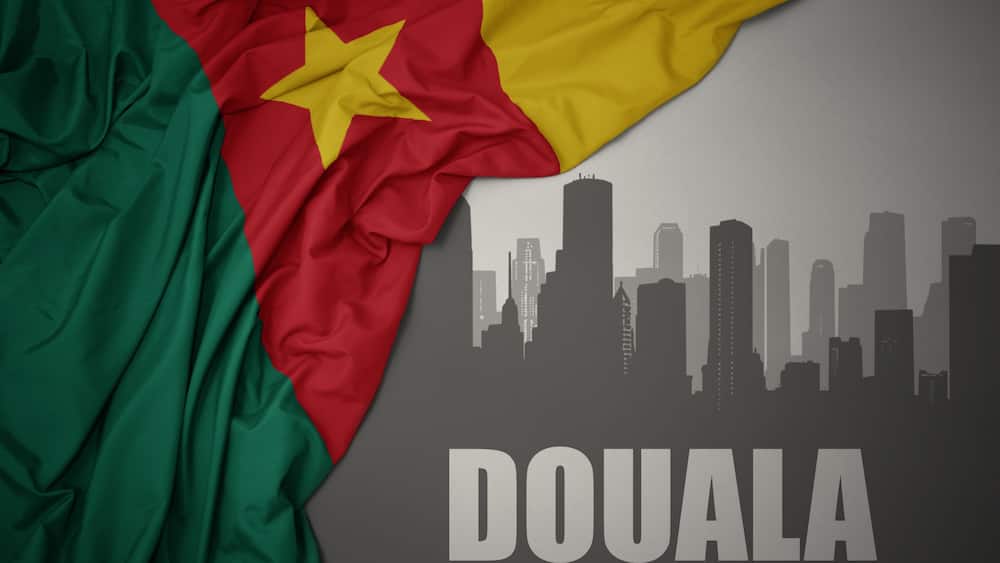 The flag of Senegal draped over a city skyline silhouette with the word 'DOUALA' at the bottom.