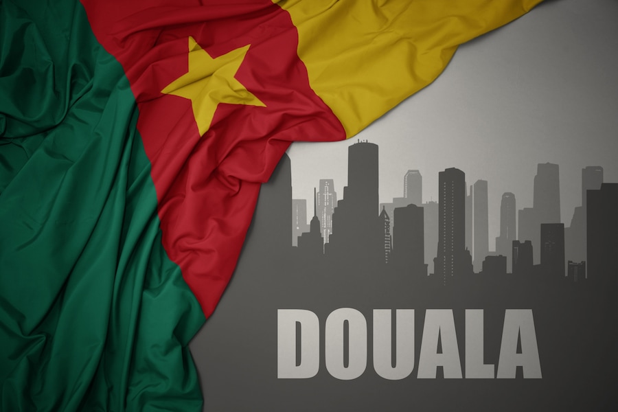 The flag of Senegal draped over a city skyline silhouette with the word 'DOUALA' at the bottom.