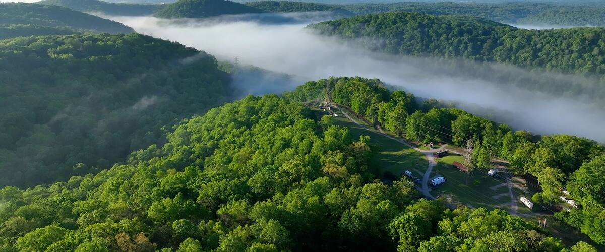 Camping in Tennessee green mountains at Norris Dam near Rocky top with morning misty clouds and sunlight