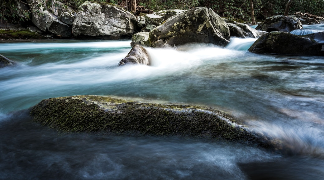 Mossy Rocky Peaks Above River Water