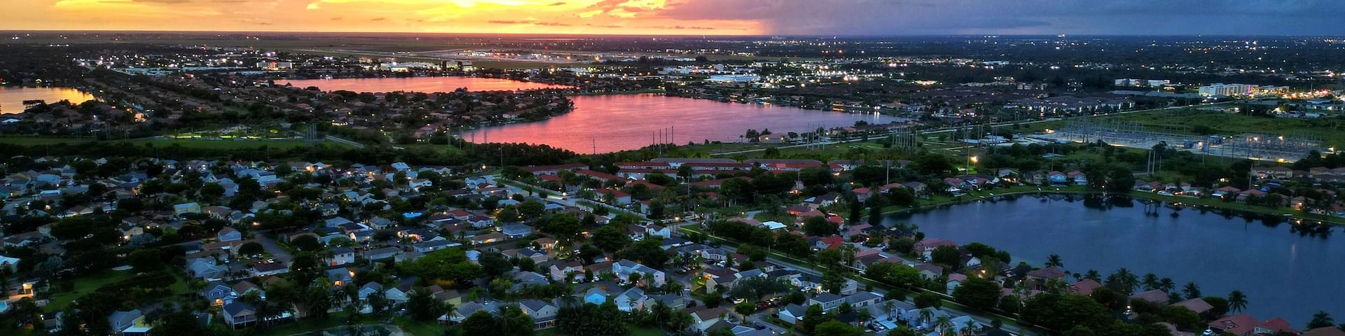 Aerial shot of Three Lakes in Miami with a beautiful golden sunset in the background