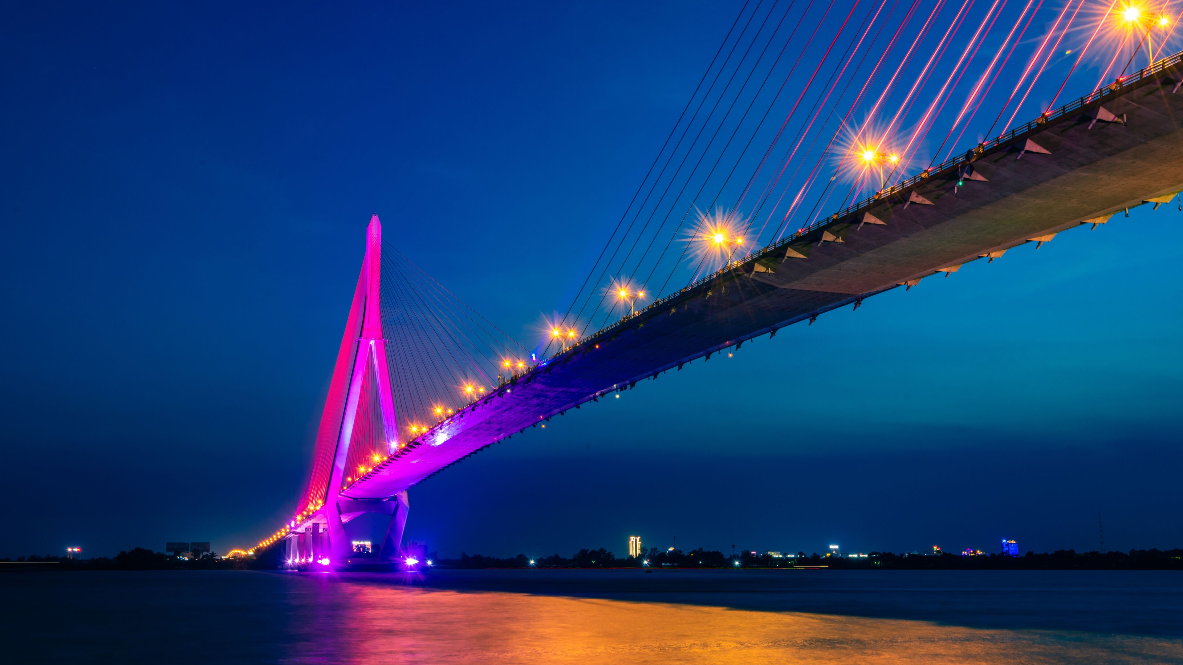 Shimmering night lights by Can Tho bridge, Vietnam