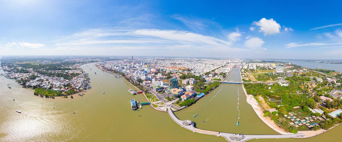 Aerial view Can Tho city skyline from above, Mekong river delta, South Vietnam. Famous tourism destination floating markets. Clear blue sky.