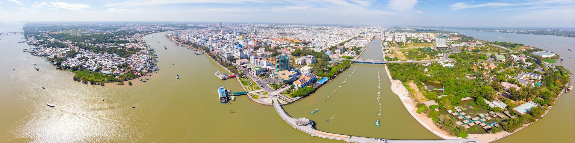 Aerial view Can Tho city skyline from above, Mekong river delta, South Vietnam. Famous tourism destination floating markets. Clear blue sky.