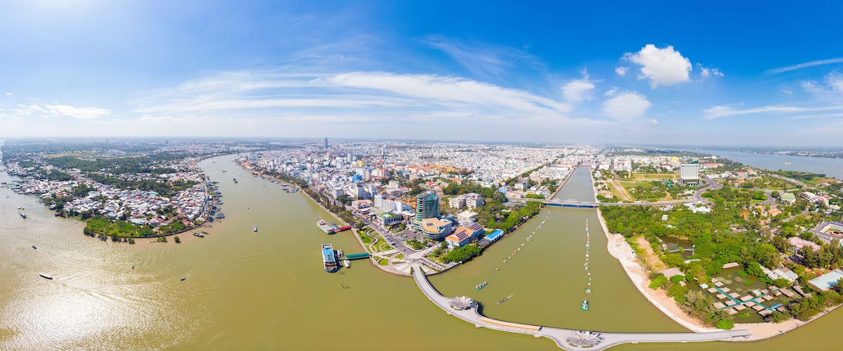 Aerial view Can Tho city skyline from above, Mekong river delta, South Vietnam. Famous tourism destination floating markets. Clear blue sky.