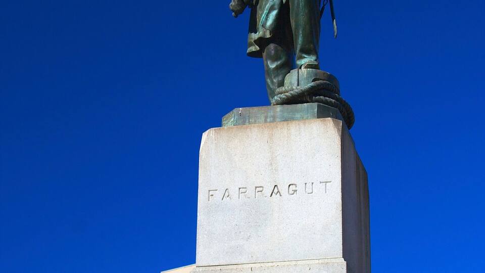 A statue of a man in uniform with a name plaque reading "FARRAGUT" on a pedestal.