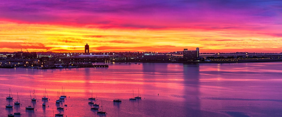 Vivid skies before sunrise with boats at anchor in Boston harbor