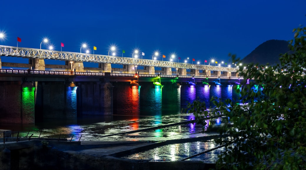 Historic Prakasam Barrage illuminated with colorful lights in the night time, Vijayawada, Andhra Pradesh, India.