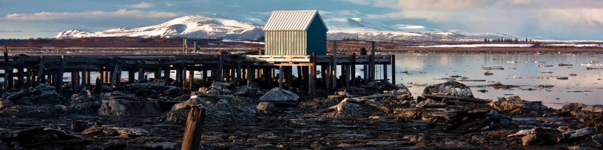 Dock Shack on an Alaskan Beach with Snow and Ice