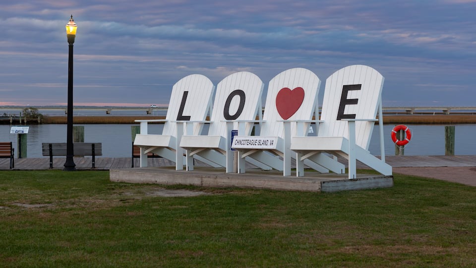 A bench with 'LOVE' spelled out in letters and a heart symbol, located on Chincoteague Island, VA.
