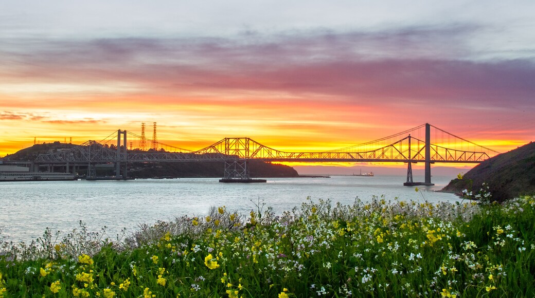 Sunset lights up the sky behind the Carquinez bridge in the Bay area of California.