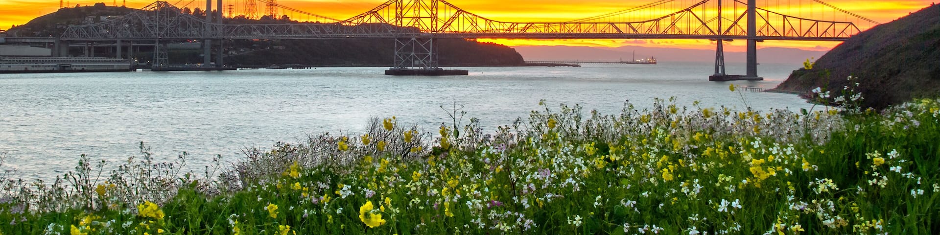 Sunset lights up the sky behind the Carquinez bridge in the Bay area of California.