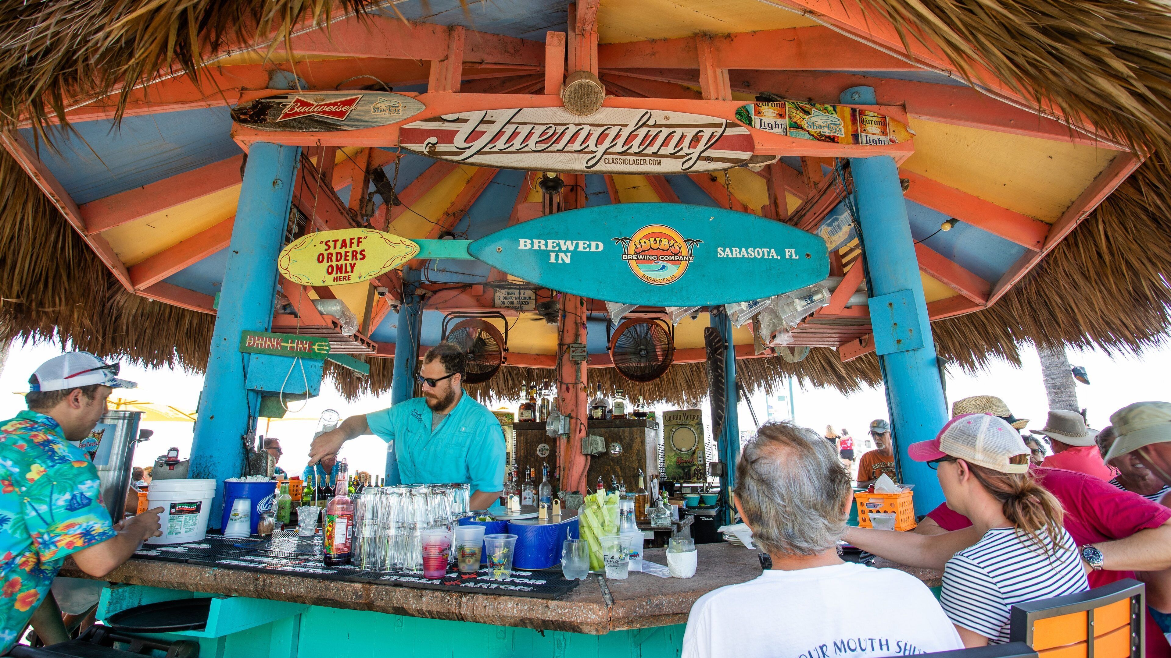 Venice showing a beach bar as well as a small group of people