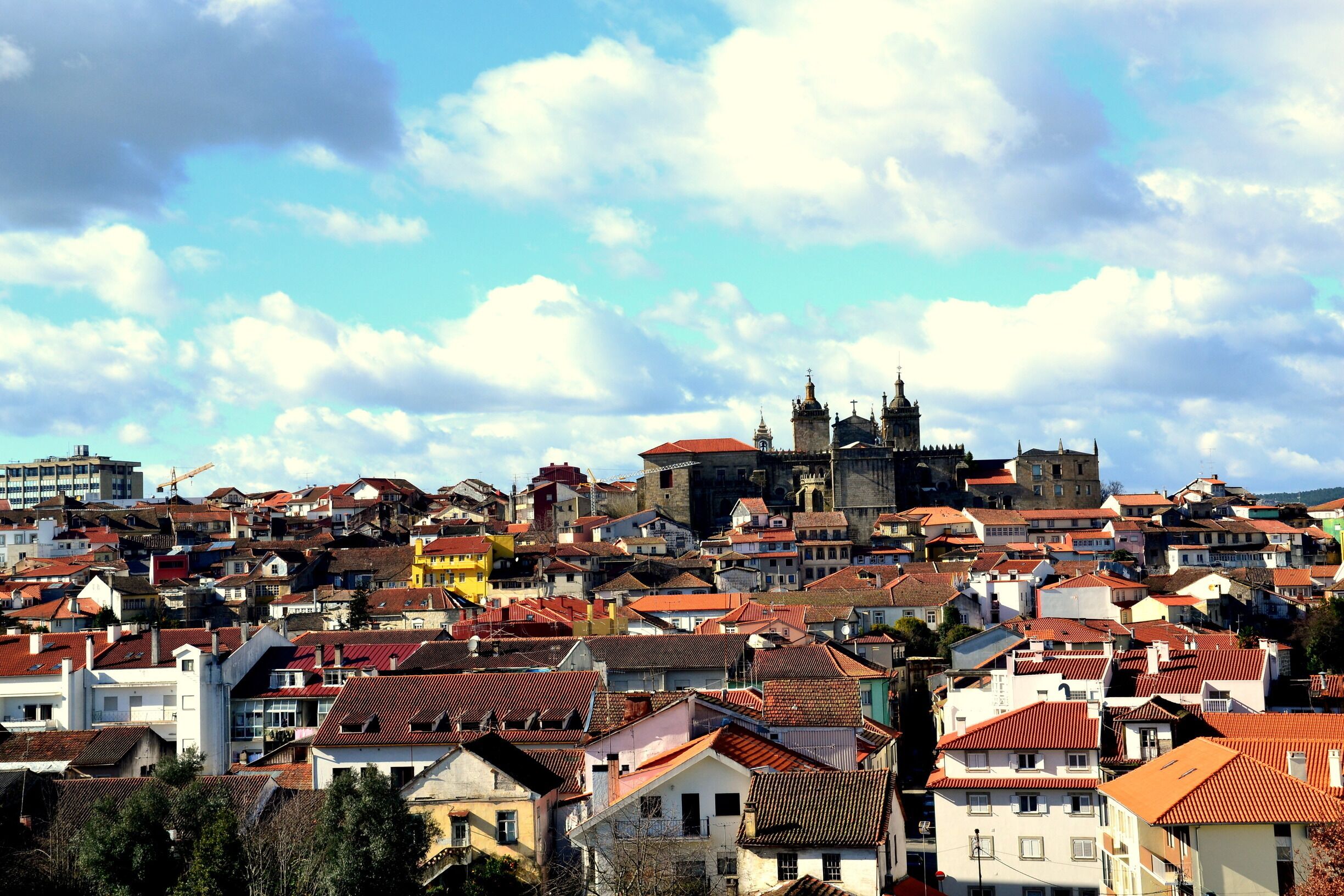 A densely packed urban area with historic buildings and a prominent church with a bell tower.