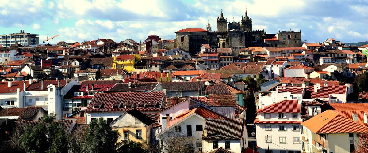 A densely packed urban area with historic buildings and a prominent church with a bell tower.