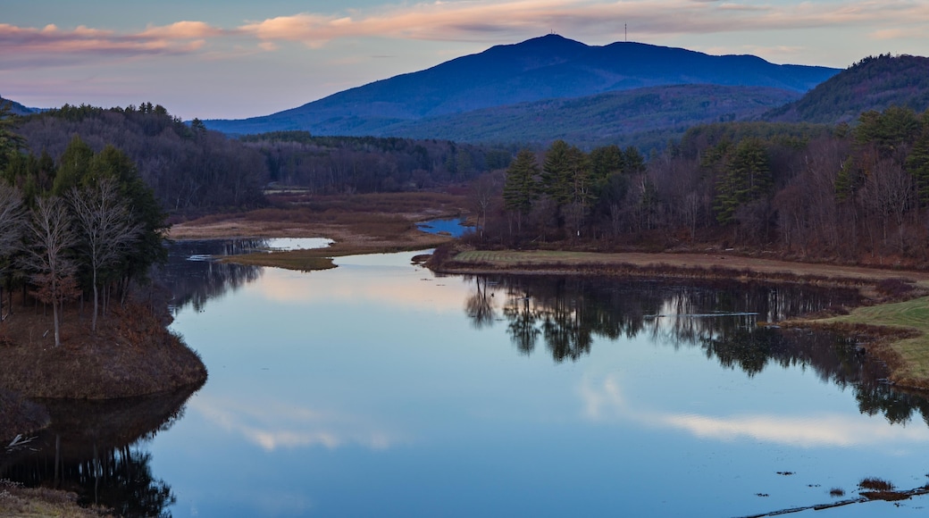 Mount Ascutney and sunset pink cloud reflections in the North Springfield Reservoir near Weathersfield, Vermont.