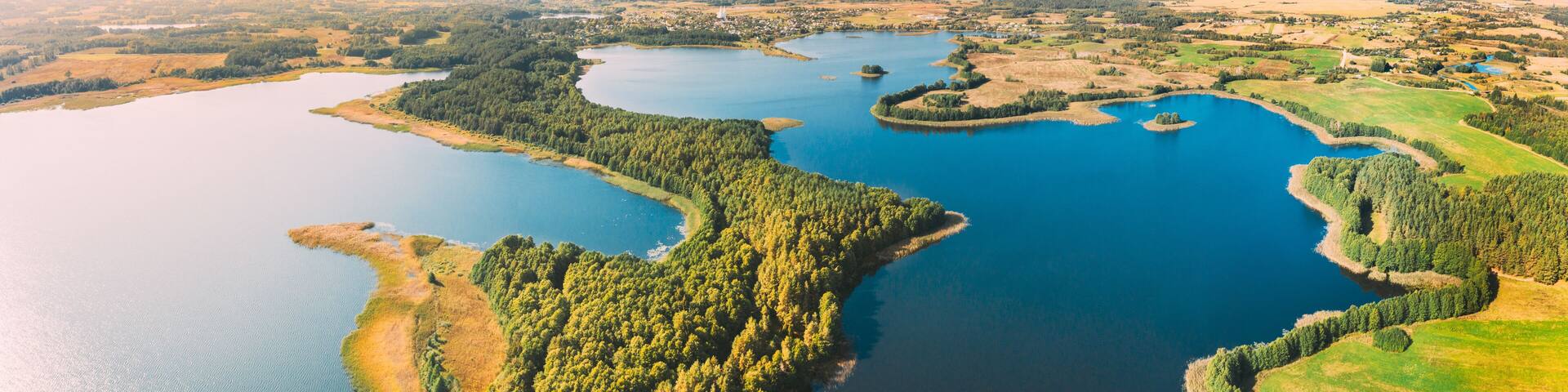 Braslaw District, Vitebsk Voblast, Belarus. Aerial View Of Nedrovo Lake, Green Forest Landscape. Top View Of Beautiful European Nature From High Attitude. Bird's Eye View. Famous Lakes. Panorama