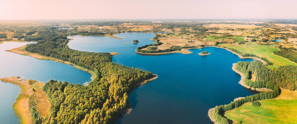 A large lake surrounded by dense forests and small islands.