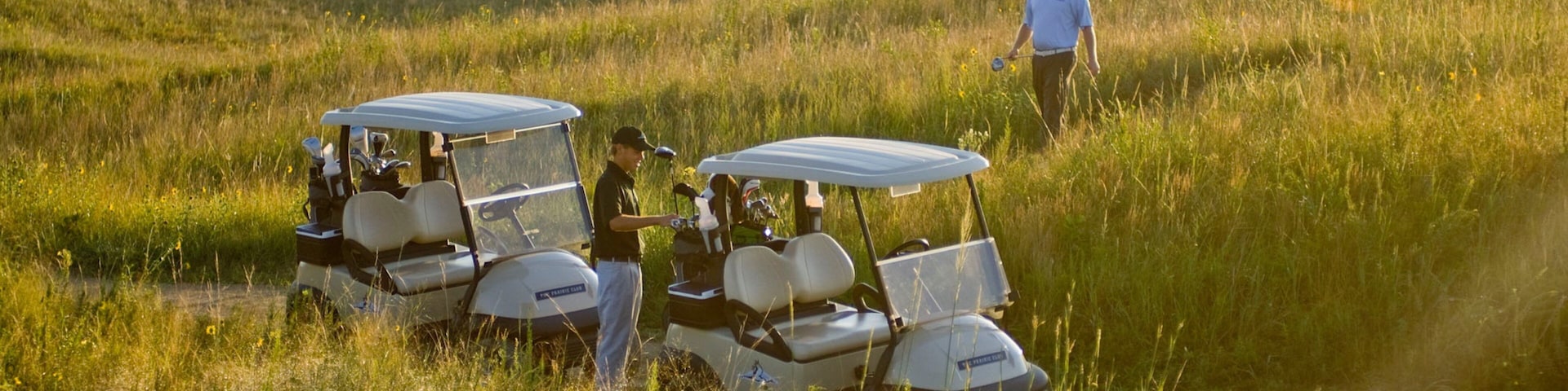 Valentine featuring golf and landscape views as well as a small group of people