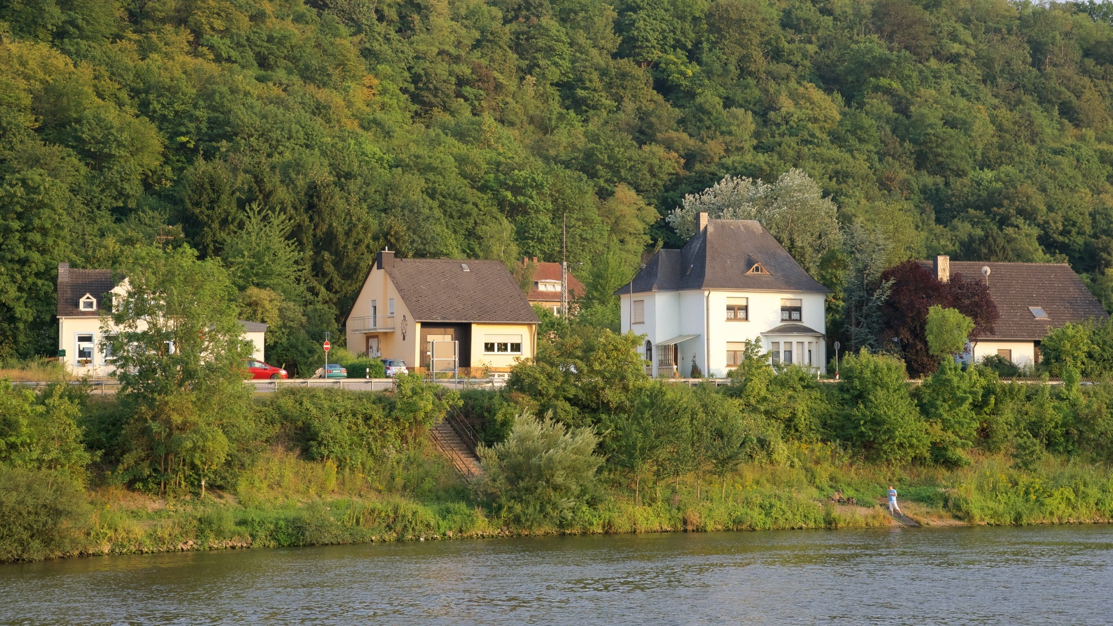 A river with houses on a hillside.