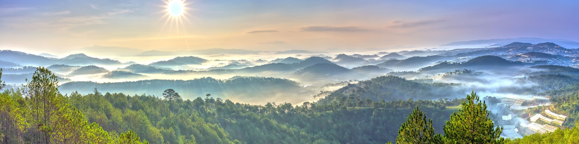 A mountainous landscape with dense forests and a valley.