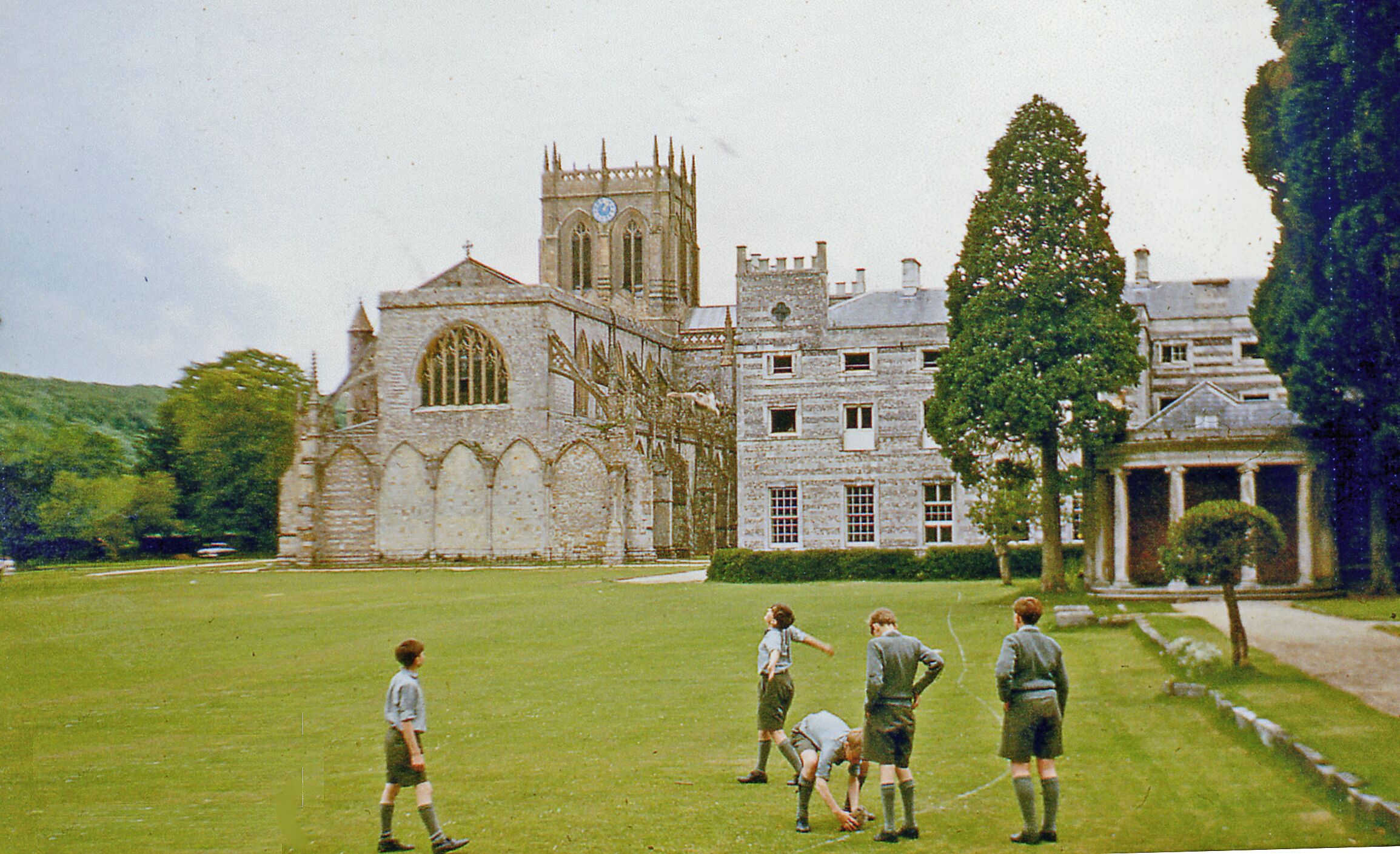Boys playing outside Milton Abbey School, 1967 View westward. You can't see them, but the boys were playing with owls. [Why does the map say 'remains' for the Abbey?]