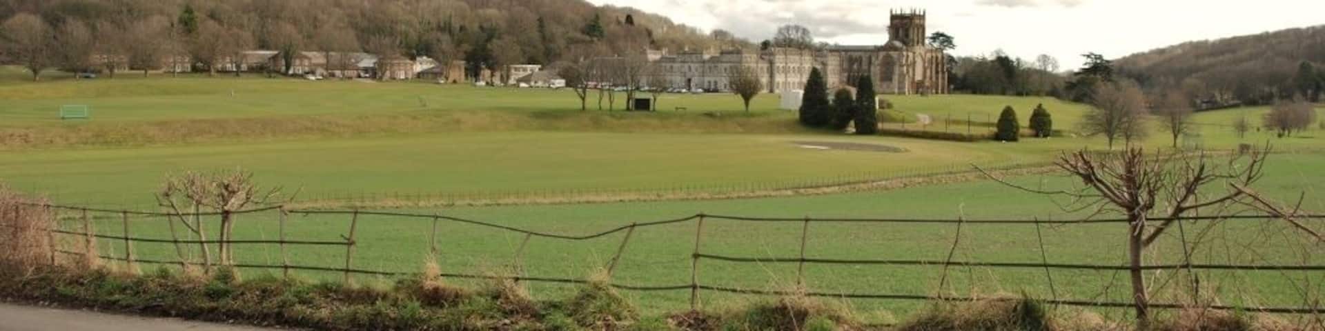 Hilton to Milton Abbas: Road The road passes through farm land and alongside Milton Abbey School seen in the distance.