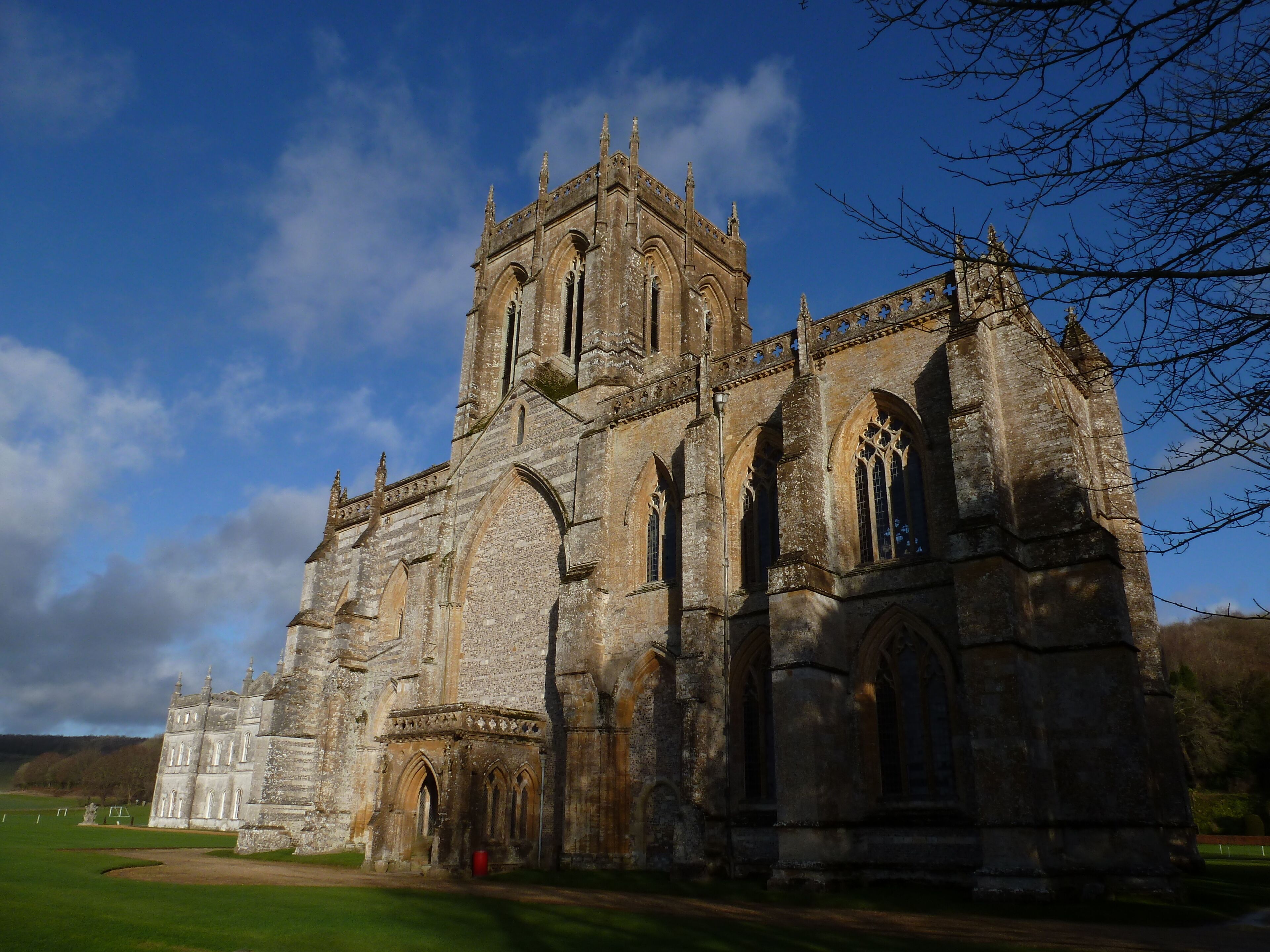 A historic stone church with arched windows and a tall tower.