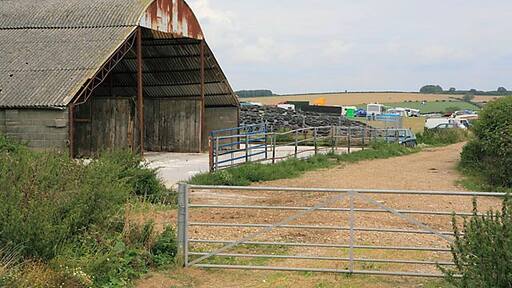 Barn on farmland southwest of Higher Dairy. With tyres weighing down a polythene sheet behind. Taken during Great Dorset Steam Fair 2006.
