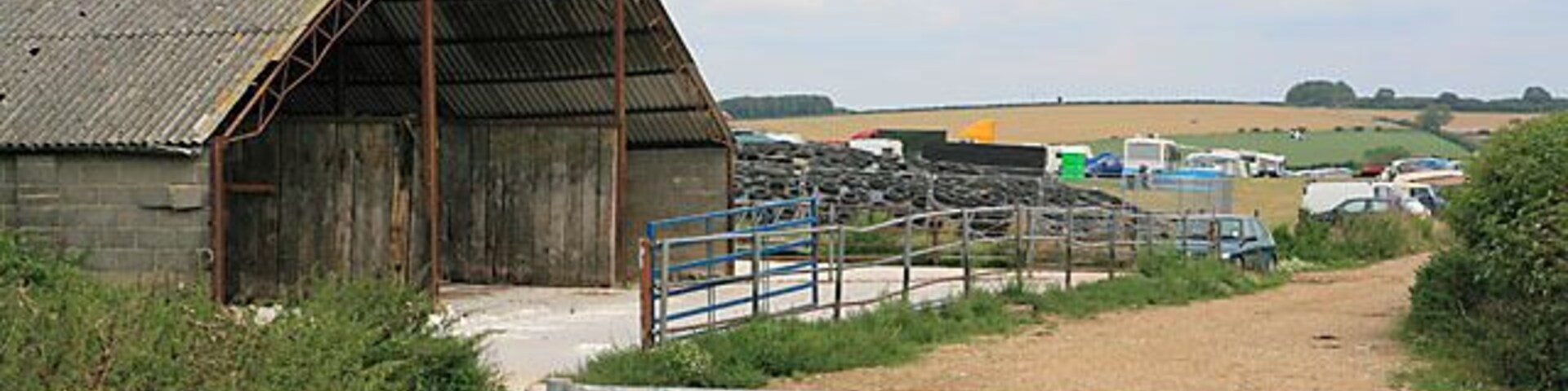 Barn on farmland southwest of Higher Dairy. With tyres weighing down a polythene sheet behind. Taken during Great Dorset Steam Fair 2006.