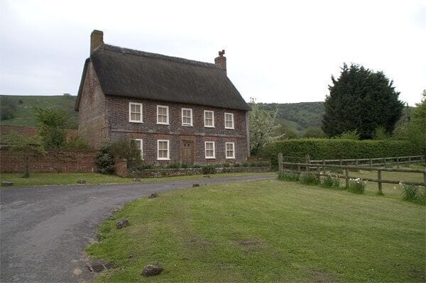 Earls Farmhouse, Belchalwell Street Bell Hill is behind this substantial thatched farmhouse, with the Wessex Ridgeway running along the top