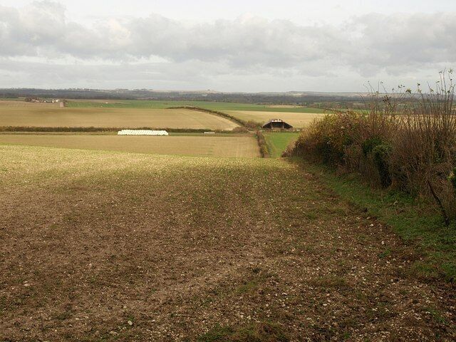 Field by lane to Tarrant Monkton The field boundary on the right meets the lane at the end of the tarmac surface, at the point where it becomes a footpath to Blandford Camp. The barn, in ST9309, is at the end of a track that runs parallel to the lane, but down to Tarrant Launceston.