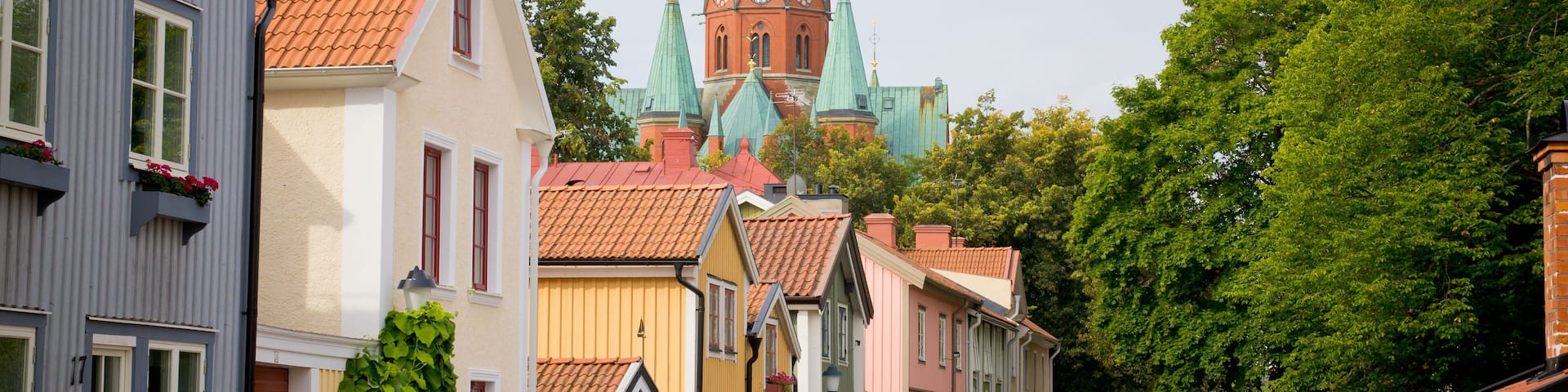 Street of houses in a town of northern Europe + church top. Sweden