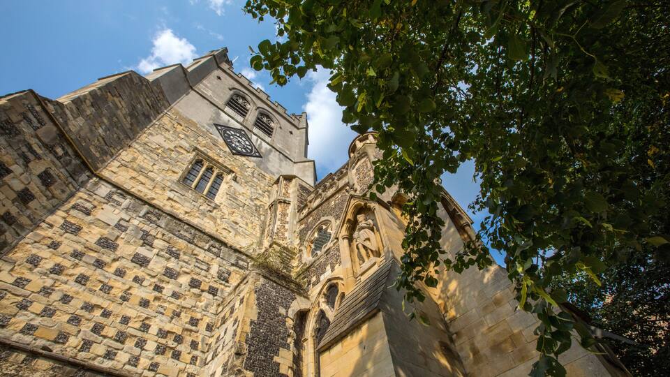 A historic stone building with intricate carvings and a clock tower.