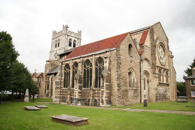 A historic church with a prominent clock tower and arched windows.