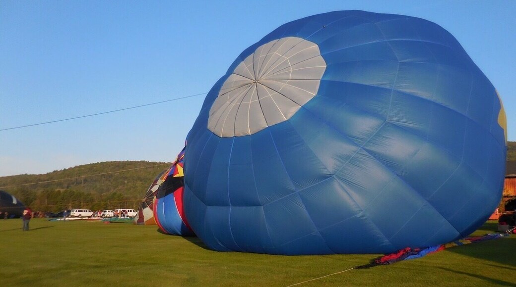 Each May, the Post Mills Airport has an Experimental Balloon Festival. This year the #blue experience was better than ever. There were more than 20 balloons. They range from a traditional basket for multiple passengers, to a single pilot suspended from a lawn chair attached to the balloon and a propane tank apparatus. The balloons are launched, as you see, typically in the early morning, or towards evening. Along with the balloons, there can be music, food, and balloon rides.