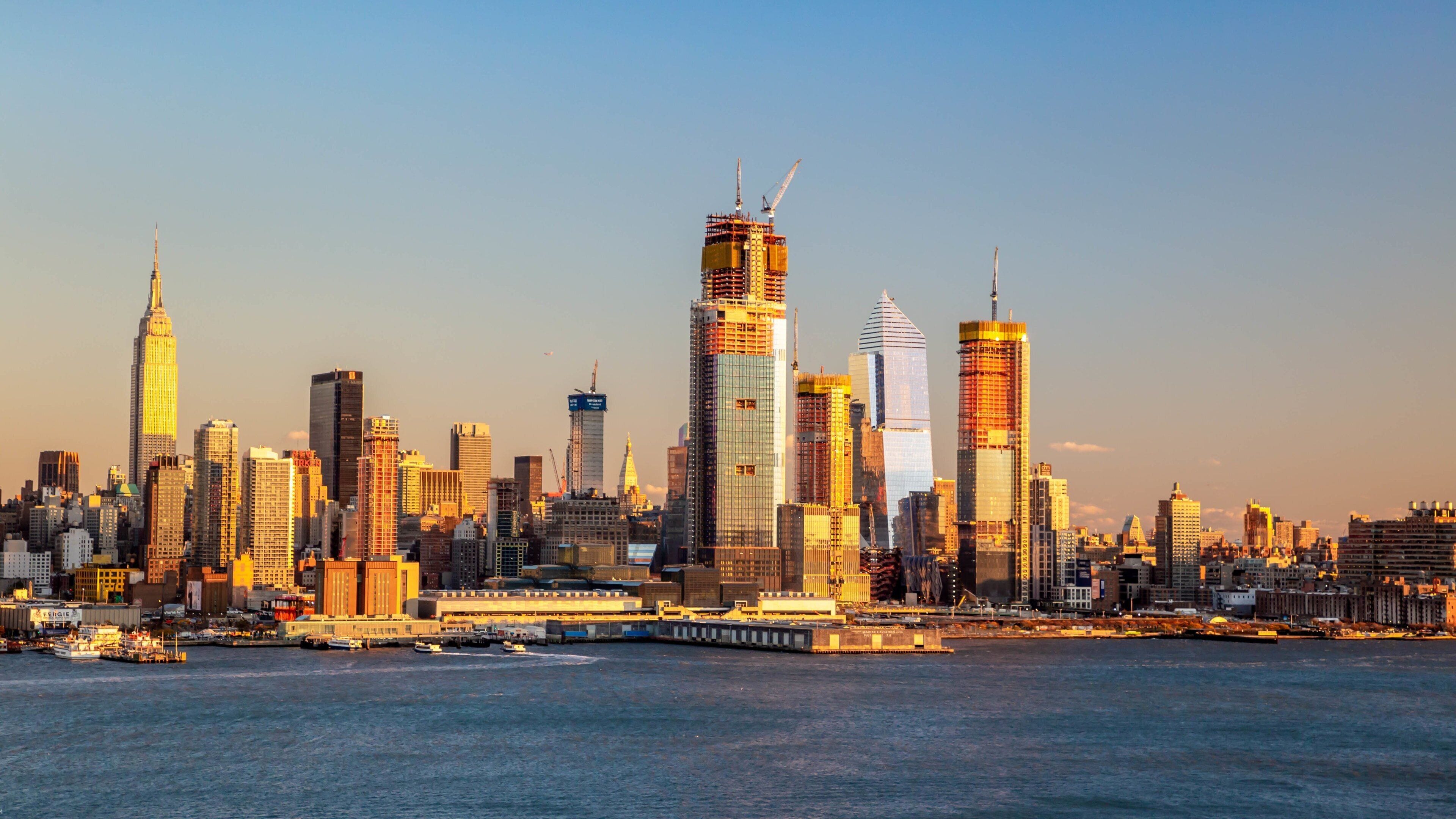 Weehawken which includes a sunset, a bay or harbor and a city