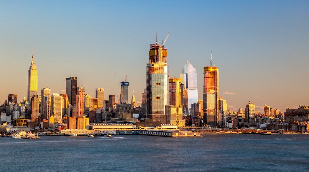 Weehawken which includes a sunset, a bay or harbor and a city