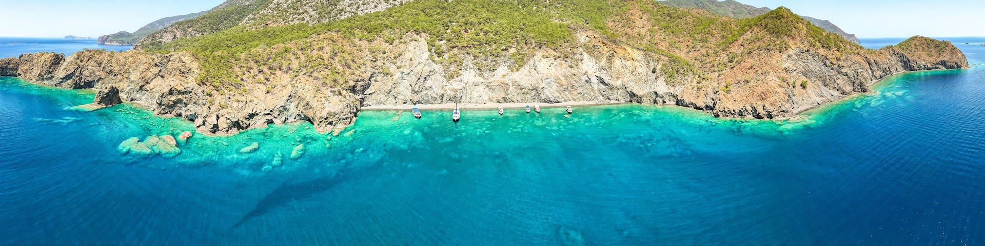 Mediterranean coastline in Turkey, with yachts on very clear blue water