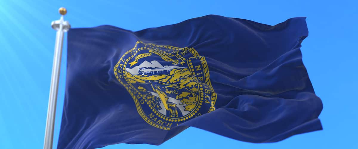 Flag of american state of Nebraska, region of the United States, waving at wind