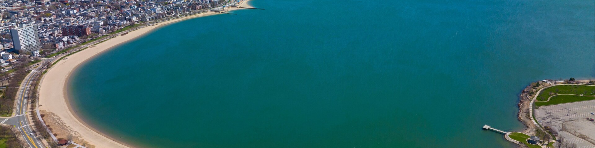 Carson Beach and Dorchester Penninsula historic district aerial view in spring from South Boston, Massachusetts MA, USA.