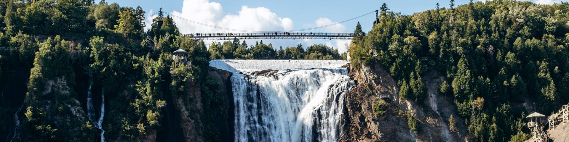 A large waterfall, a bridge, and a dam.