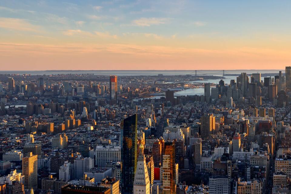 Aerial panoramic view of New York City at Sunset . Brooklyn (left), Midtown and Lower Manhattan (center) with Jersey City (right). USA