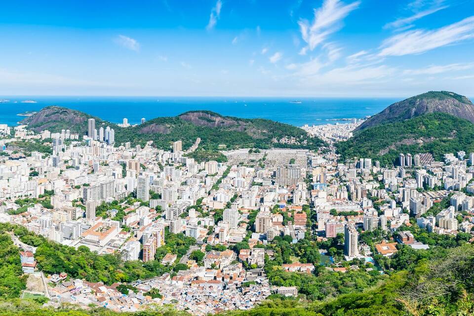 Scenic panorama of the Rio de Janeiro, Brazil city skyline with Sugarloaf Mountain Botafogo and Guanabara Bay under bright blue Brazilian skies