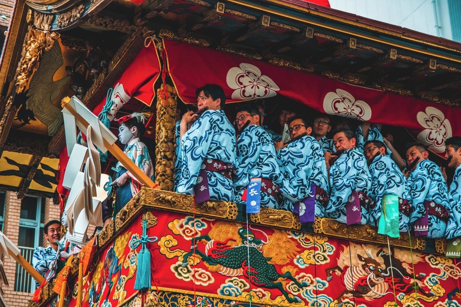 The Gion Matsuri Festival is Japans most famous festival. Musicians sit in huge floats that are pushed/dragged around town in Kyoto while the musicians play their flutes. There are two types of floats in The Gion Matsuri Parade, Yama and Hoko. There are 23 Yama and 10 Hoko. The Hoko floats can be up to 25 meters tall and weigh up to 12 tons.
The main procession of the floats are held on the 17th of July, which is when this photo was taken. #Festival