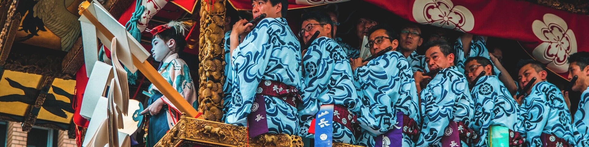 The Gion Matsuri Festival is Japans most famous festival. Musicians sit in huge floats that are pushed/dragged around town in Kyoto while the musicians play their flutes. There are two types of floats in The Gion Matsuri Parade, Yama and Hoko. There are 23 Yama and 10 Hoko. The Hoko floats can be up to 25 meters tall and weigh up to 12 tons.
The main procession of the floats are held on the 17th of July, which is when this photo was taken. #Festival