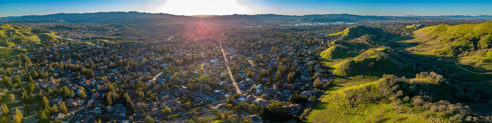 Wallnut Creek Aerial Panorama. Suburban city and green hills at sunset