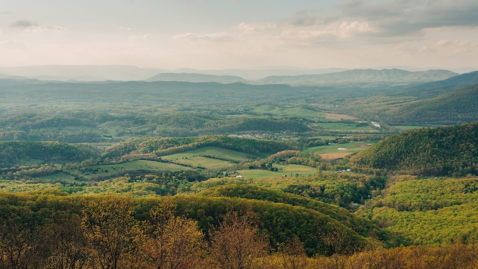 Rolling hills, a valley, and scattered buildings.